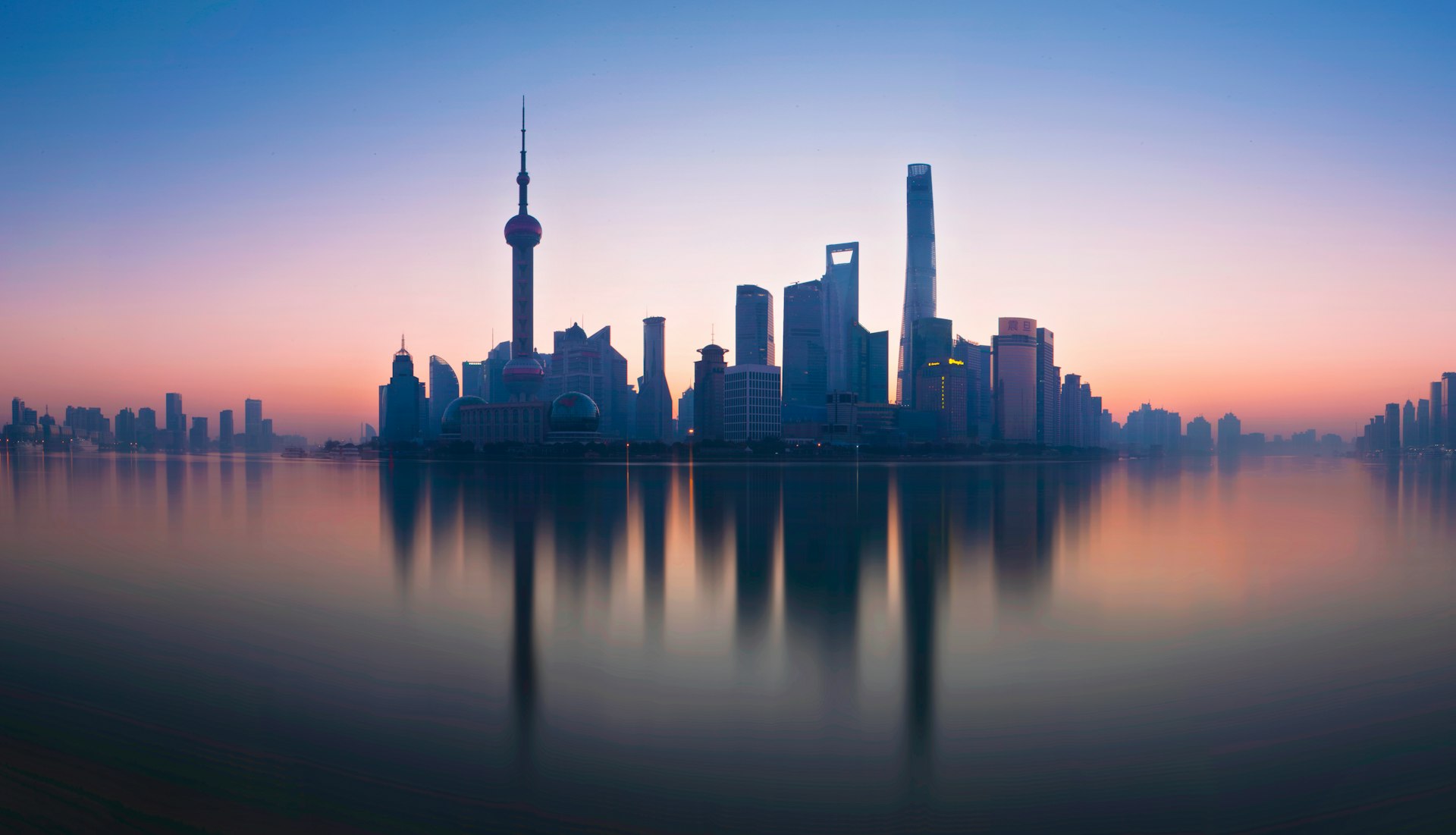 Shanghai skyline reflecting on the Huangpu River at dawn